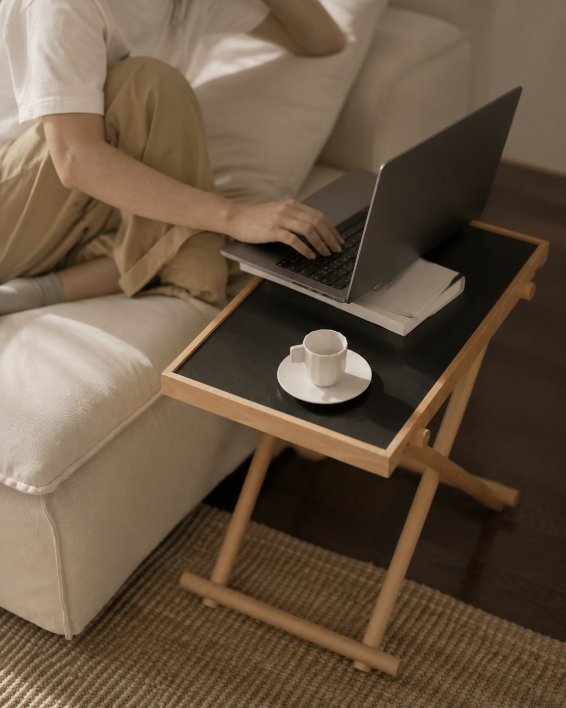 Black Aster folding side table used with a laptop
