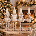 Four-piece adjustable Christmas figurine set with bear, Santa, snowman and reindeer by a fireplace